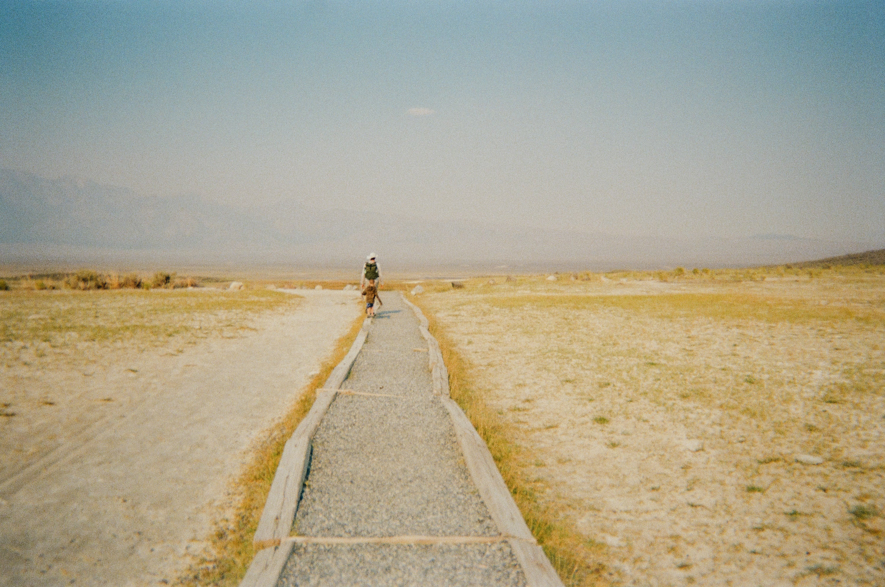 picture of dad hiking with his kid in the desert